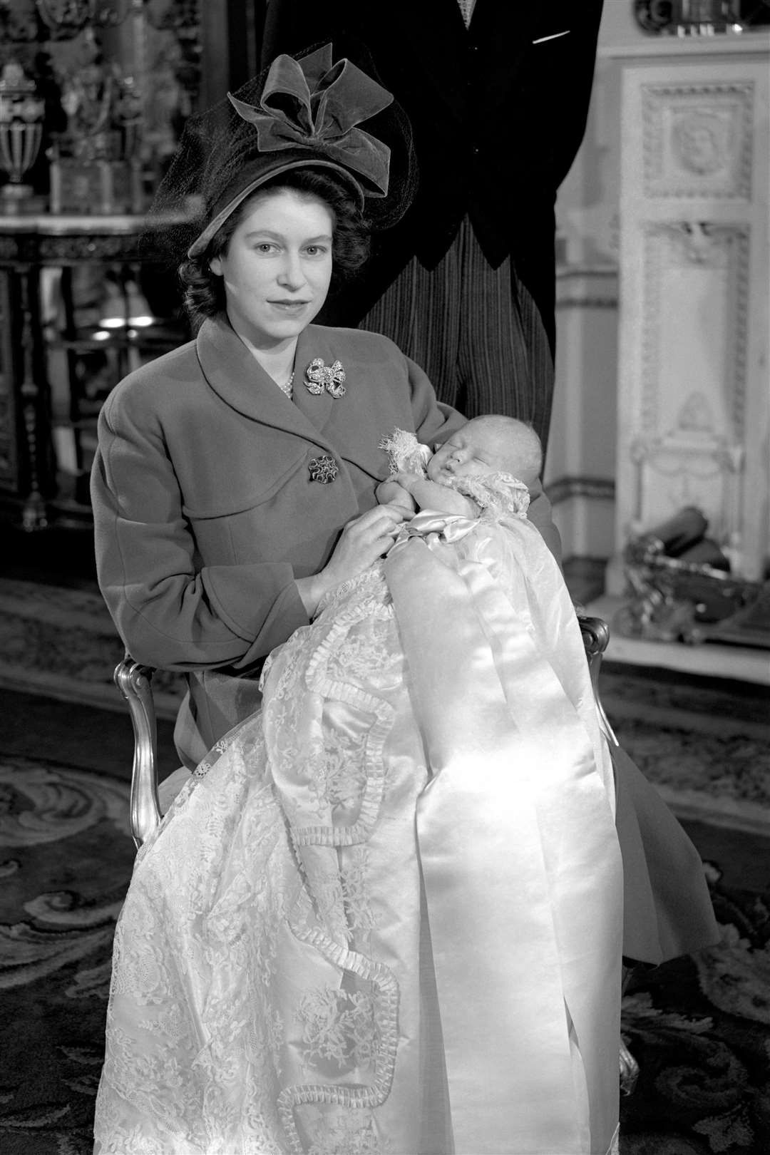 Princess Elizabeth, later Queen Elizabeth II, holding her baby son Prince Charles at his christening in 1948 (PA)
