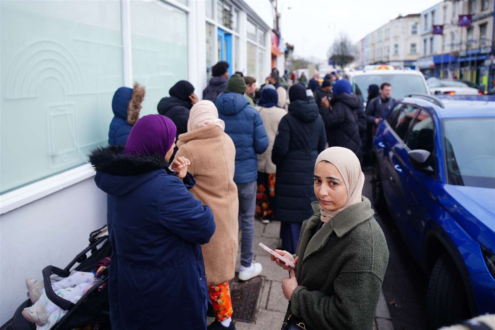 People in line outside the St Pauls dental practice in Bristol last month (Ben Birchall/PA)