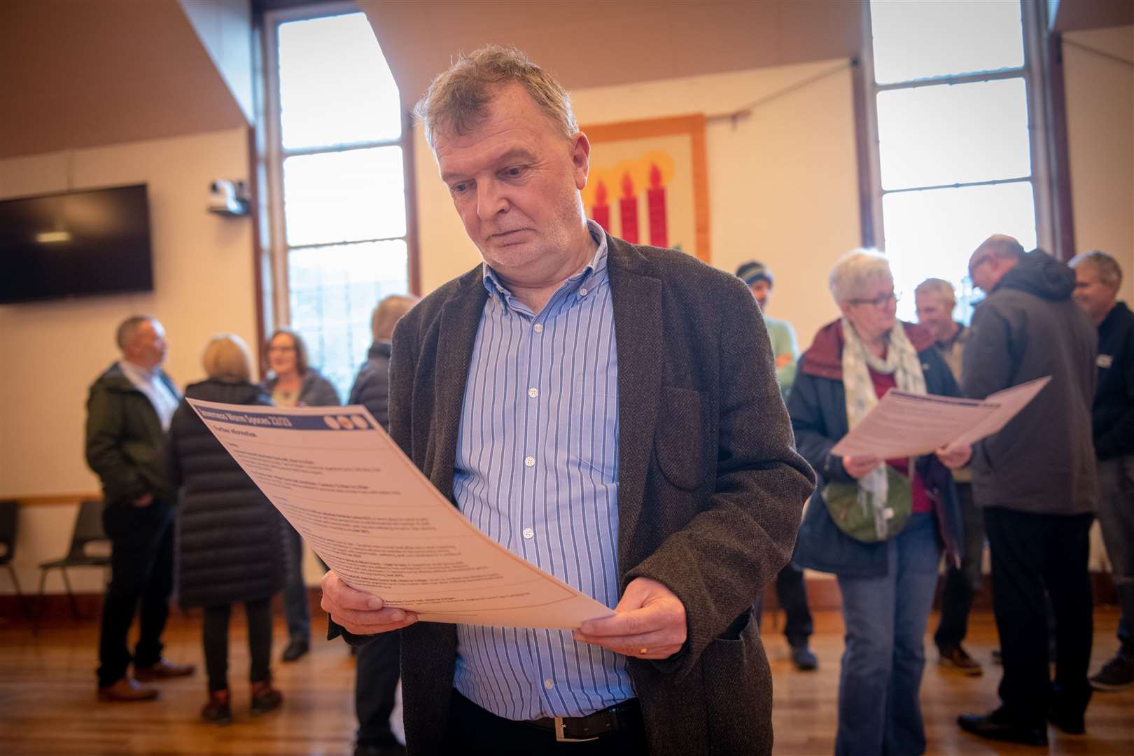 Alasdair Christie checks out the list of warm spaces in Inverness during the launch at Hilton Church.