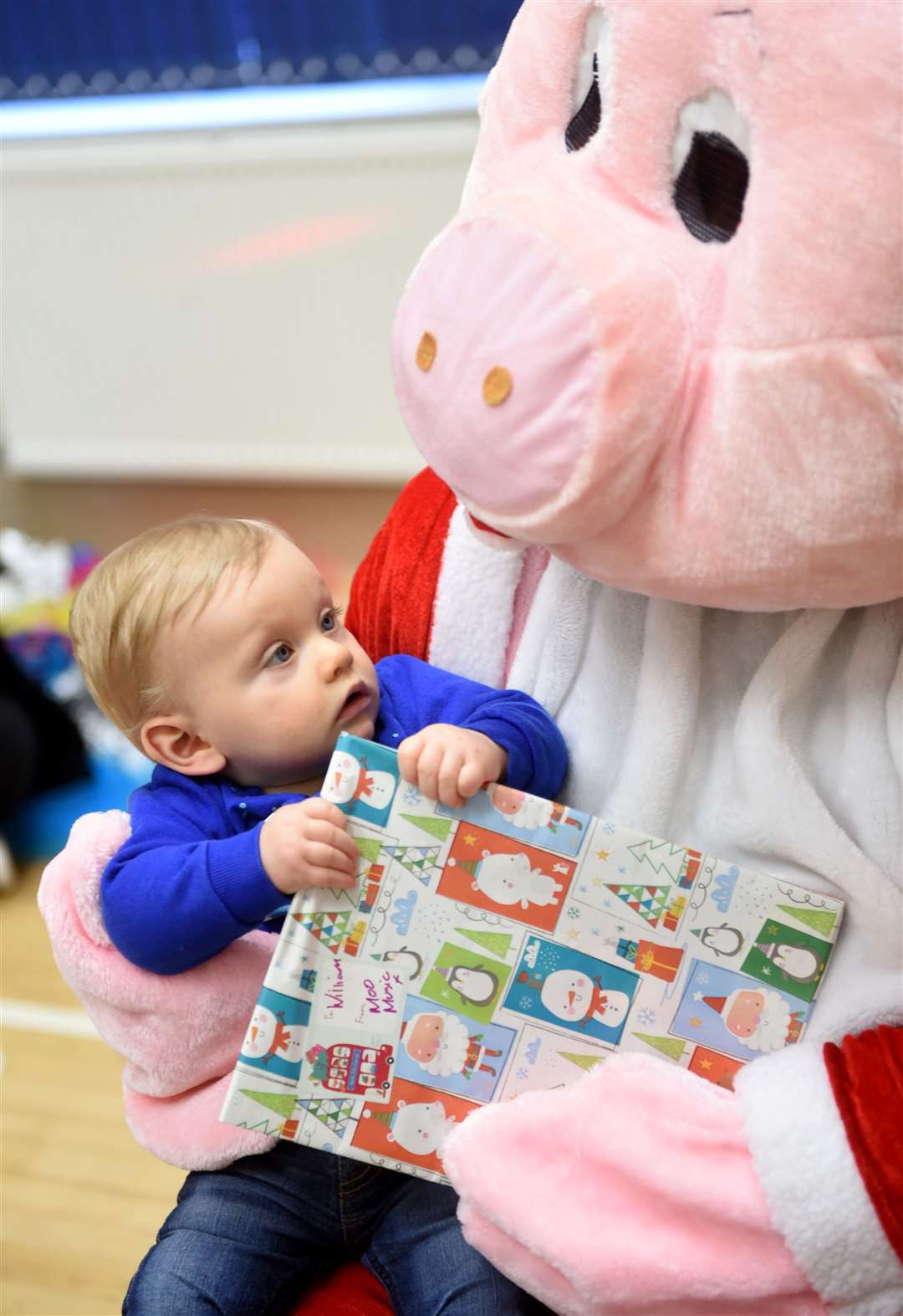 Moo Music Highland Christmas party, Balloch Hall, Inverness. William Bond gets a present from Peppa Pig Santa. Picture: Callum Mackay.