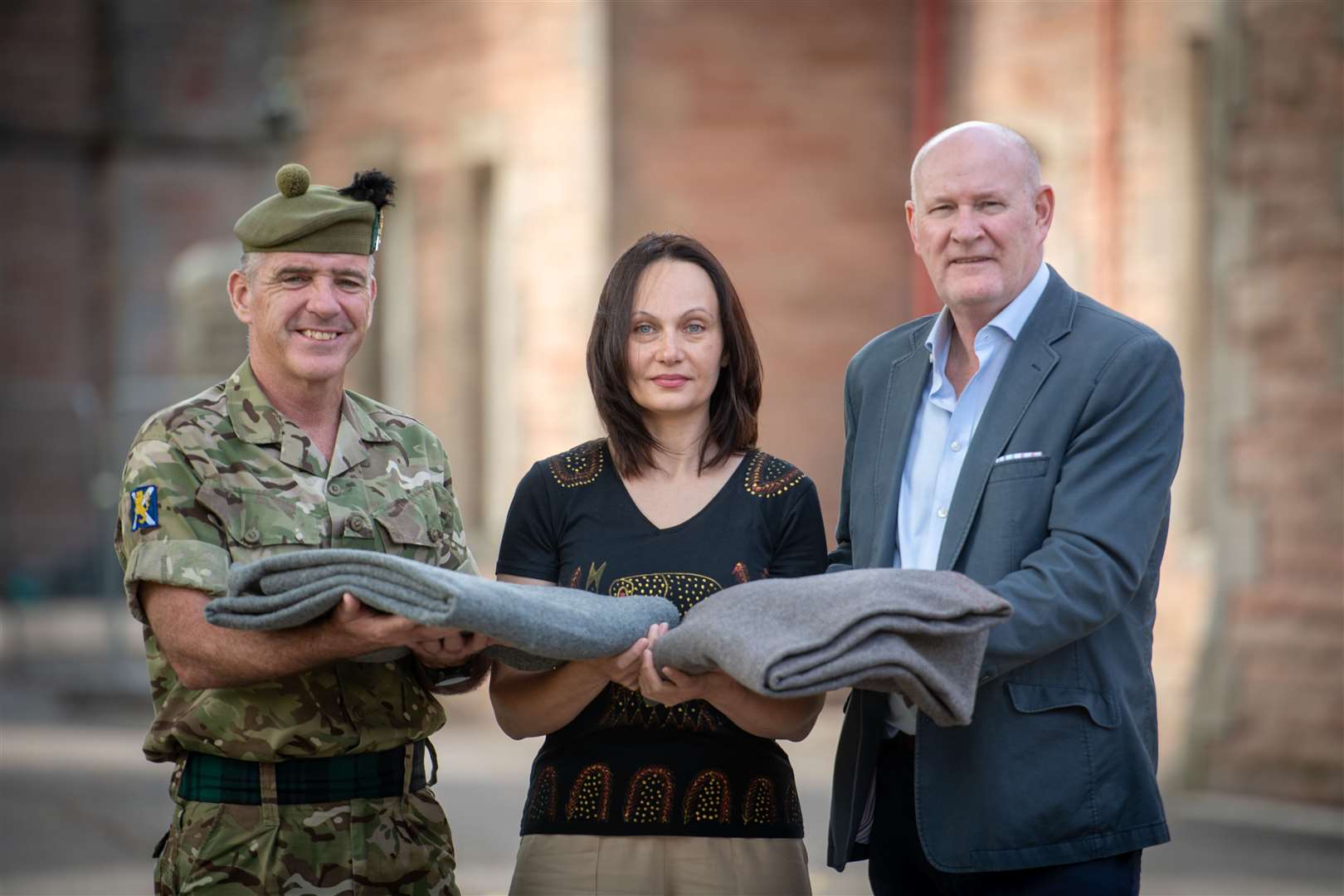 Lt Col Alan Grant, Maryna Kudriavtseva and Col Brian Ross oversee the dispatch of blankets from Cameron Barracks in Inverness to Ukraine. Picture: Callum Mackay.