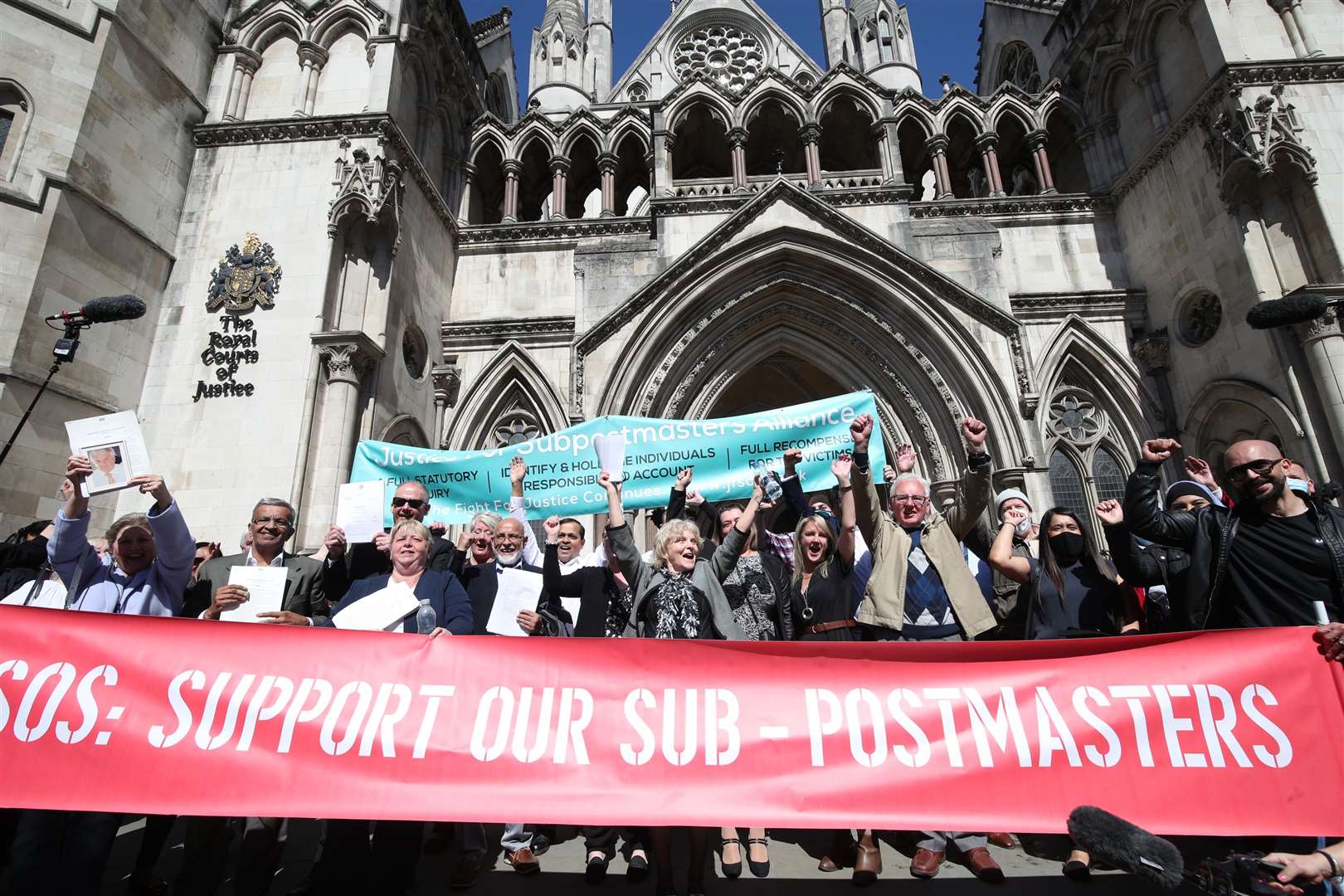 Former Post Office workers celebrate outside the Royal Courts of Justice in London after having their convictions overturned by the Court of Appeal (Yui Mok/PA)