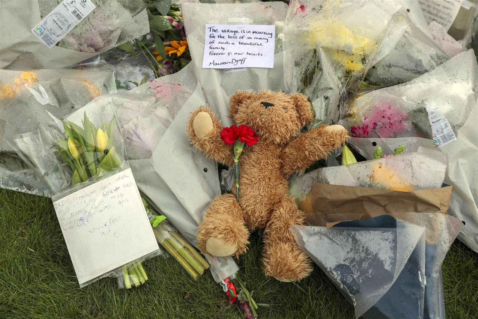 Floral tributes left outside Chinnor Community Church in Oxfordshire in memory of four members of the Powell family (Steve Parsons/PA)