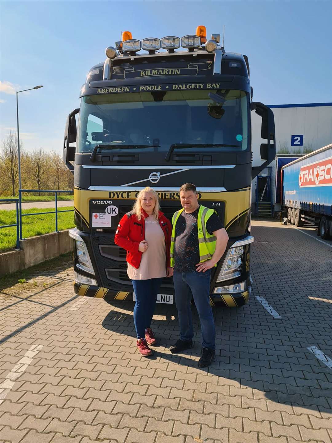 Natalia Kusmierczuk, left, the humanitarian aid co-ordinator at the Polish Red Cross( PCK) with driver Piotr Klimek outside the warehouse in Lublin, Poland, where he delivered the Highlands for Ukraine aid.