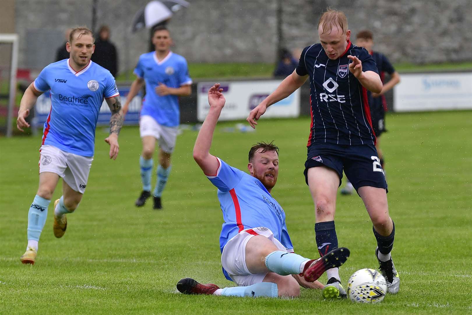 Wick's Rob Campbell stretches to tackle Ross County's Ethan Kevill in a pre-season friendly.