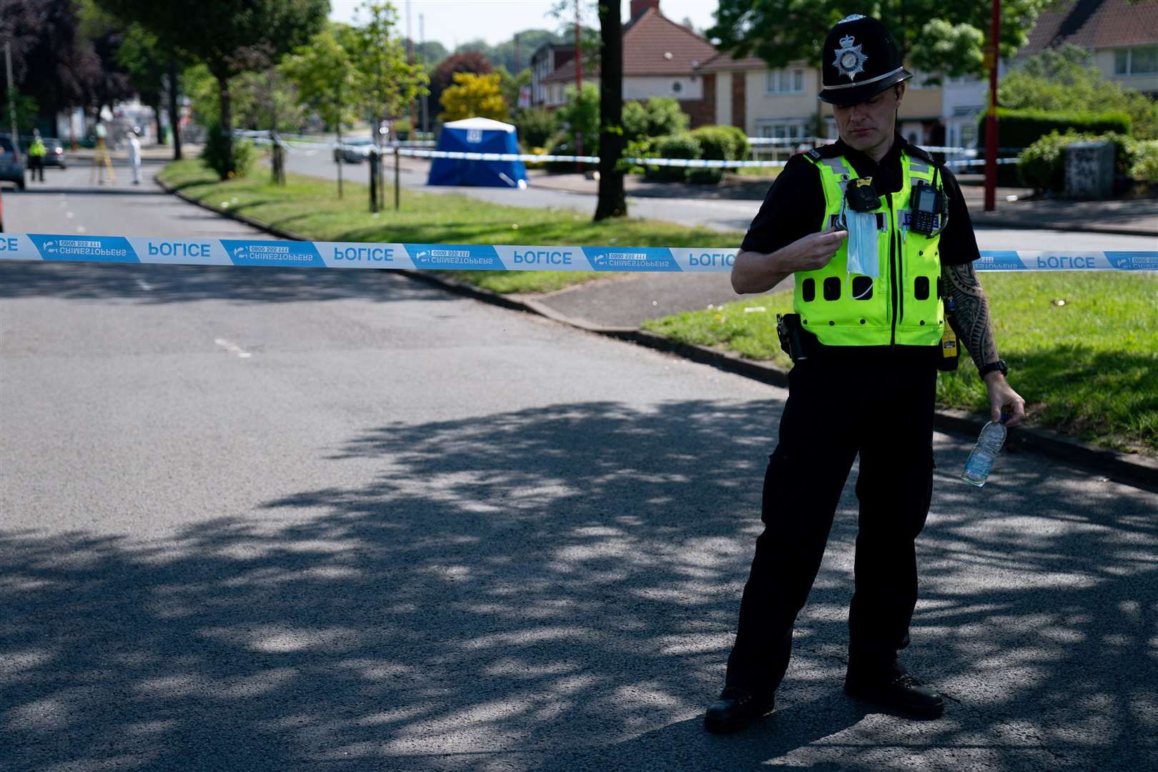 A police officer near the scene on College Road, a day after Dea-John’s death (Jacob King/PA)