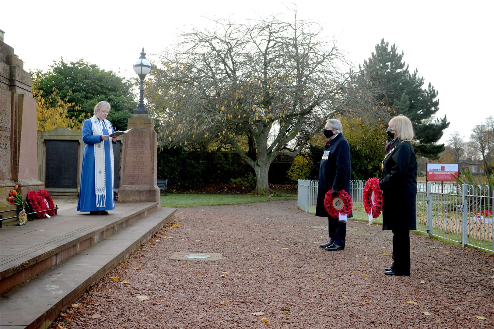 Inverness Provost Helen Carmichael and Vice Lord Lieutenant Colonel Douglas Young place wreaths at the war memorial in Cavell Gardens, Inverness, watched by Rev Fiona Smith, moderator of Inverness Presbytery.