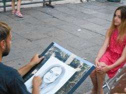 A portrait artist at work in Venice