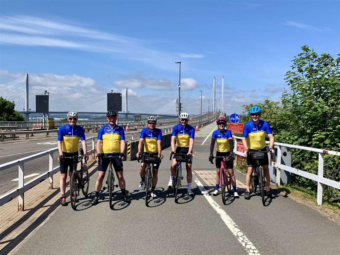 The cyclists cross the Forth Road Bridge during the Lang Way Doon challenge.