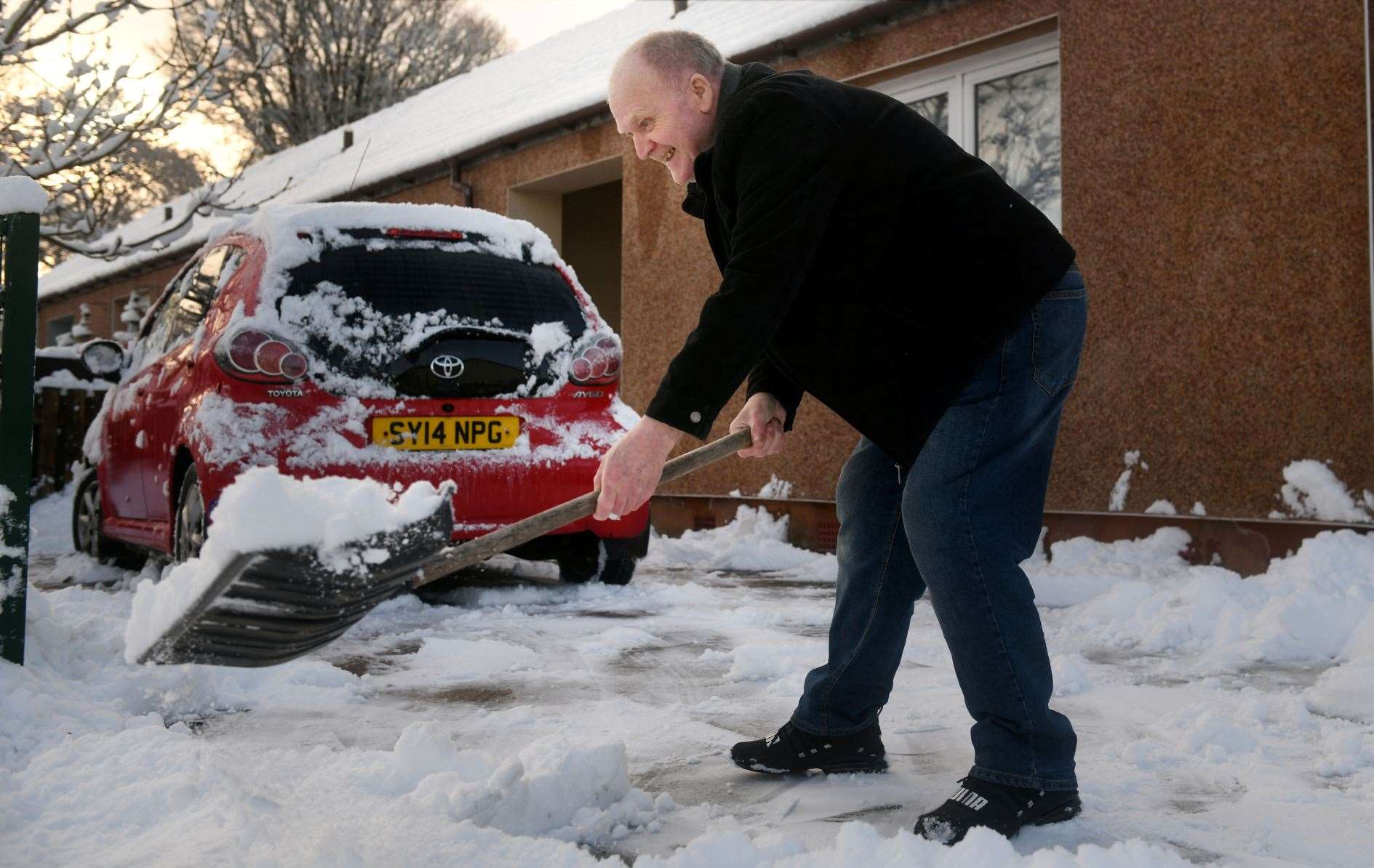 Hugh Williamson shovelling the snow on his driveway. Picture: James Mackenzie