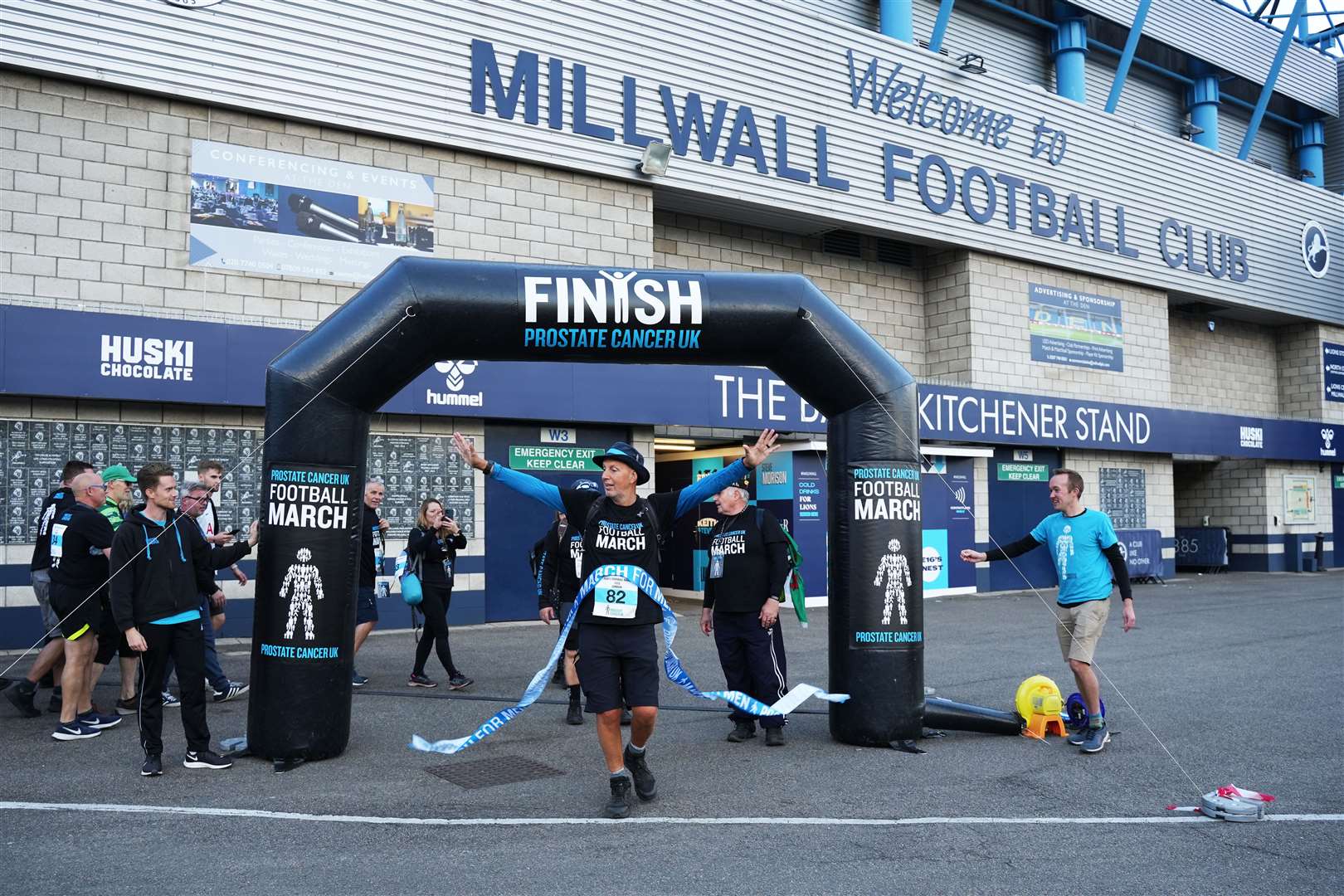 Kevin Webber crossing the finish line at Jeff Stelling’s football march outside Millwall Football Club (Rosie Lonsdale/Prostate Cancer UK)