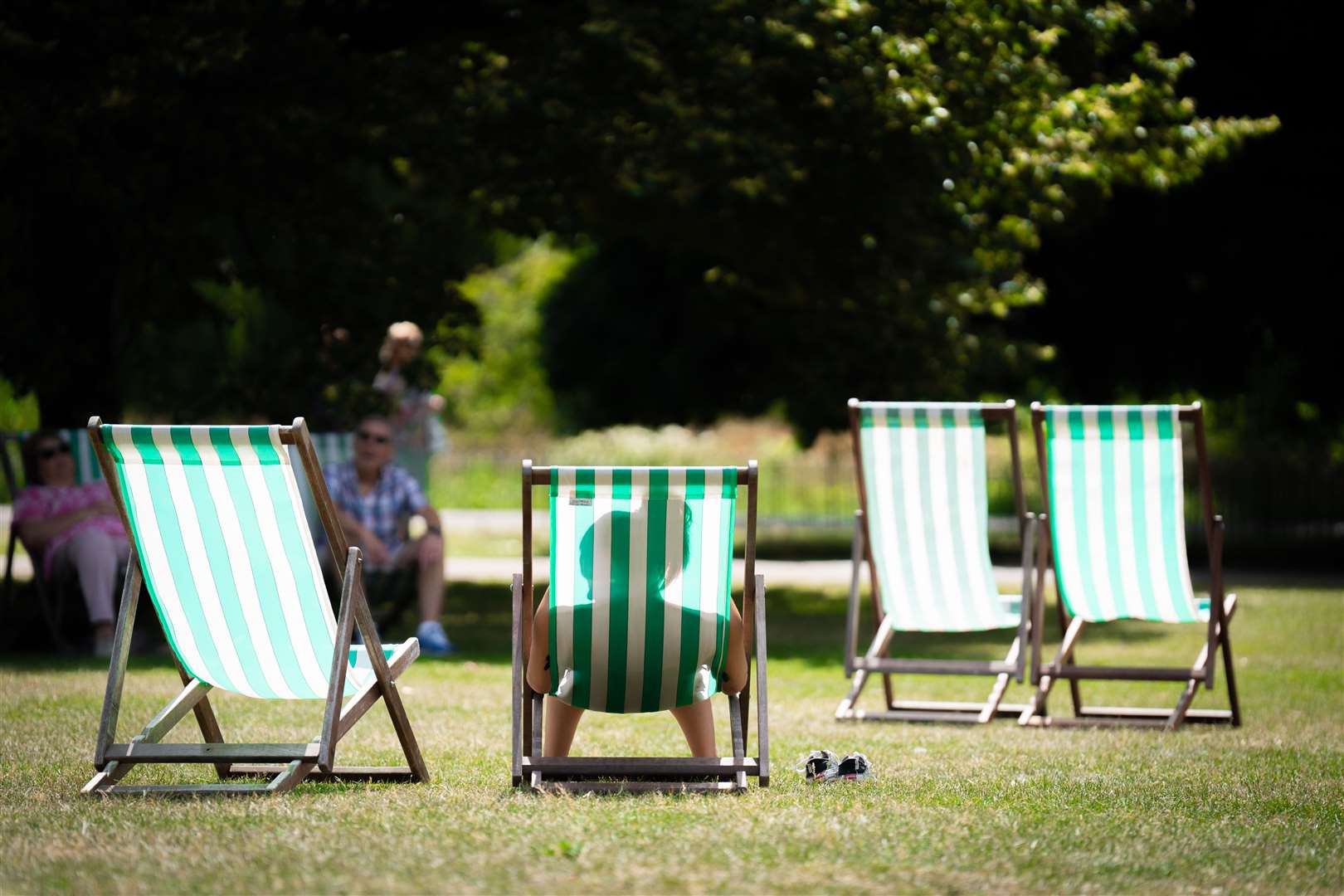 A person sits in a deckchair in St James’ Park in London (James Manning/PA)