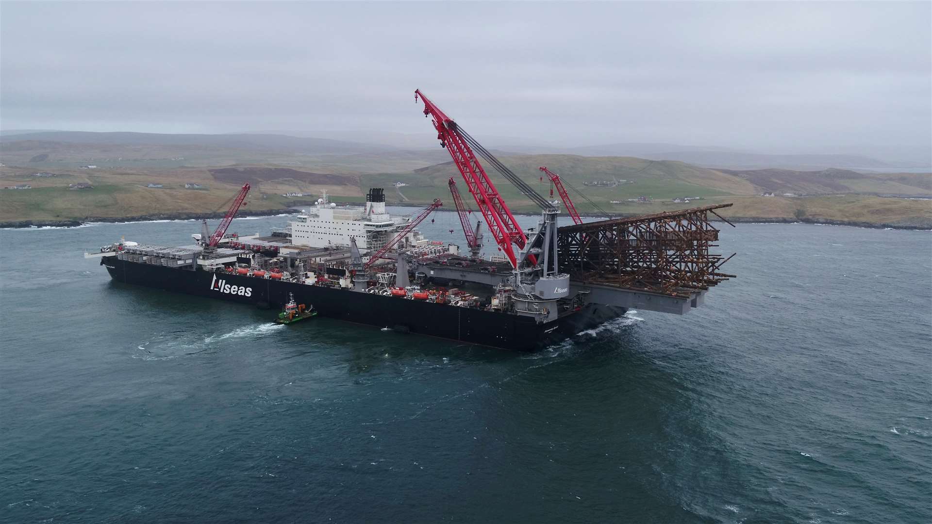 Pioneering Spirit, the world’s largest construction vessel, arrives in Dales Voe with the 8500 tonne Ninian Northern jacket for decommissioning. Picture: Rory Gillies/Shetland Flyer Aerial Media.