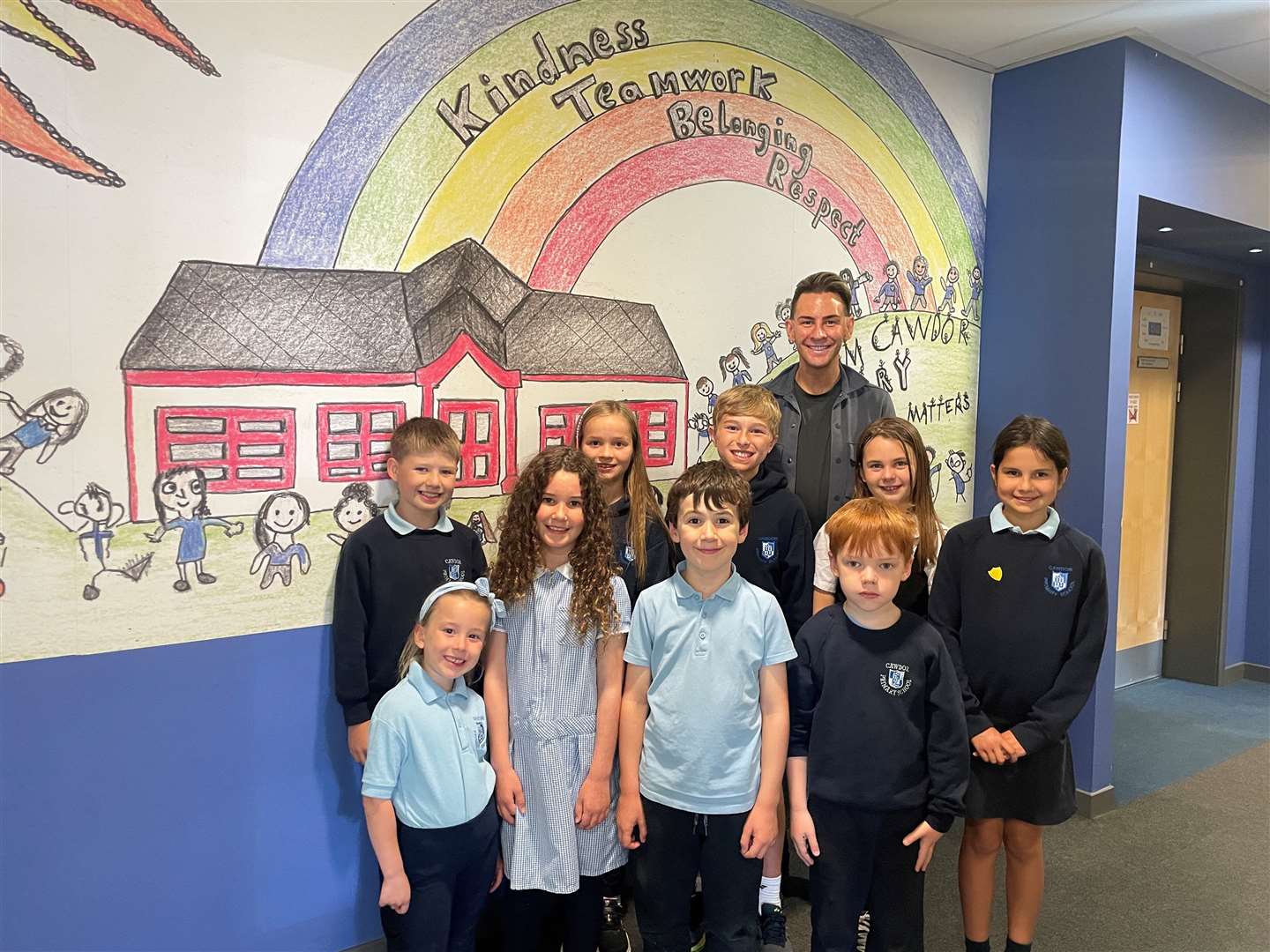 Head teacher James Cook with a group of students at Cawdor Primary.