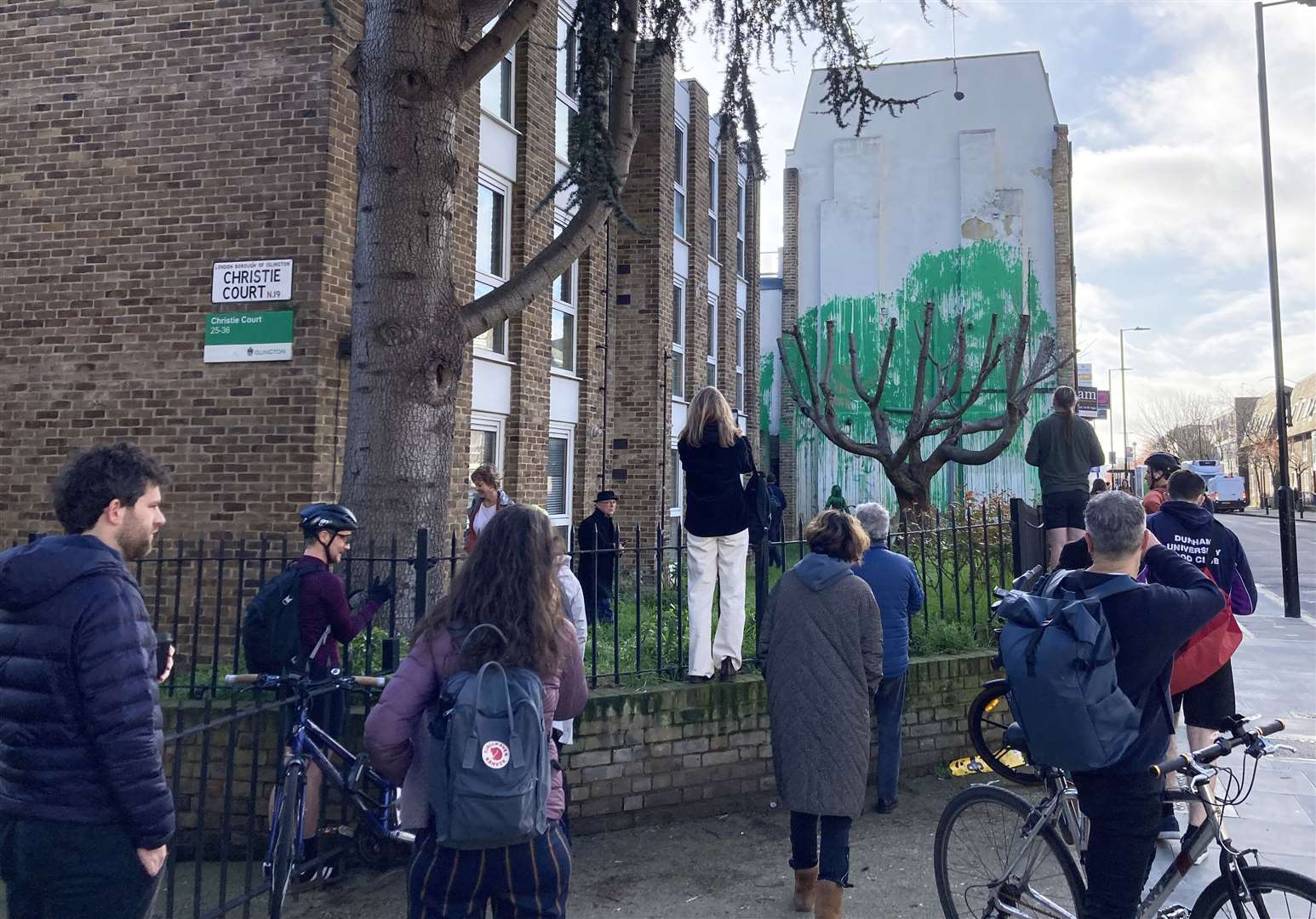 Members of the public look at the new Banksy artwork (Ella Nunn/PA)