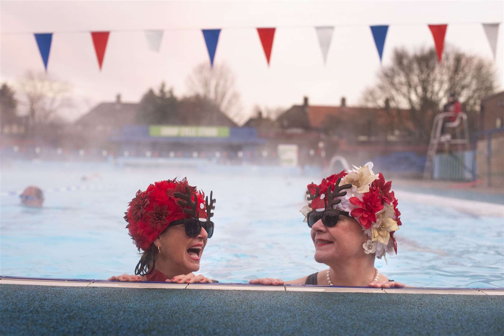 Jessica Walker and Nicola Foster, known as the Lido Ladies, swim at Charlton Lido in Hornfair Park, London, on its first day of reopening (Victoria Jones/PA)