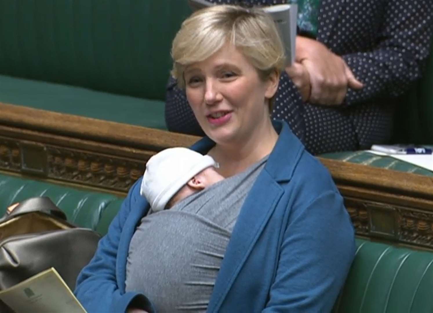 Labour MP Stella Creasy speaking in the chamber of the House of Commons with her newborn baby strapped to her (House of Commons/PA)