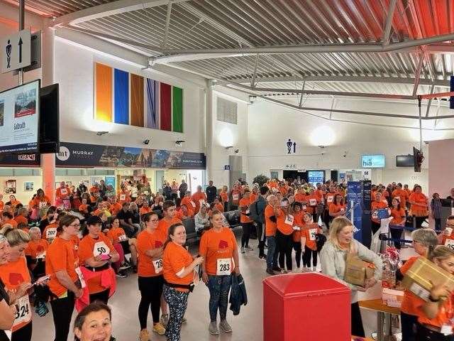 A sea of orange in Inverness Airport terminal before the run gets under way.