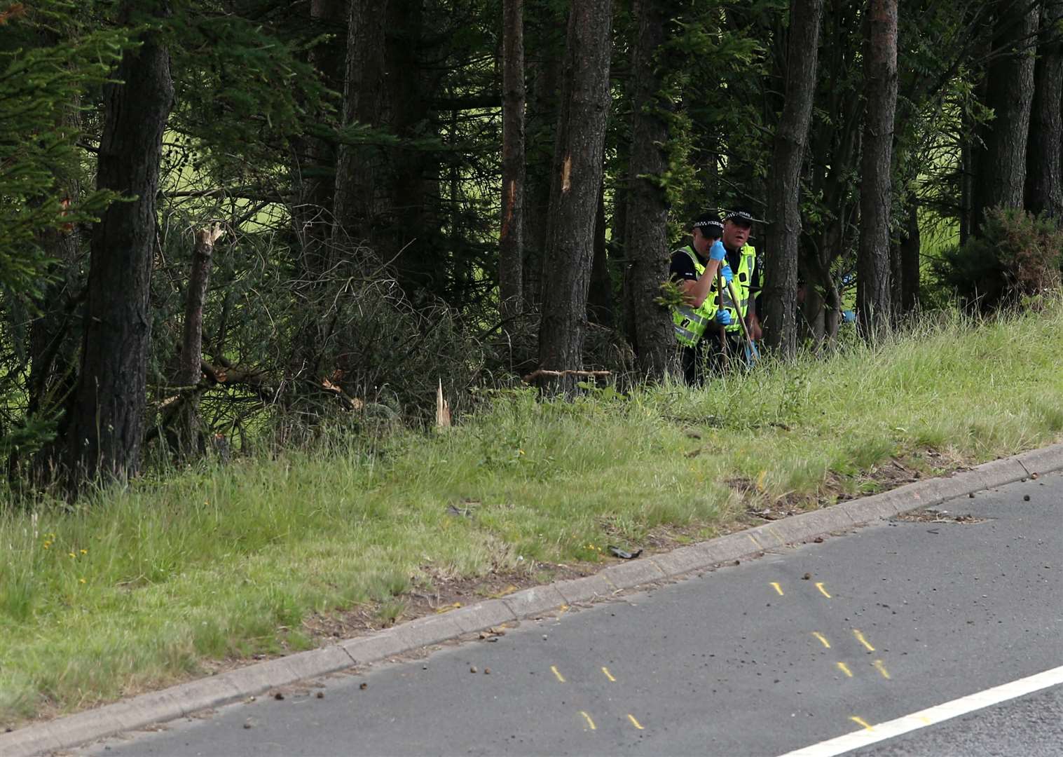 Police at the scene of the crash after the couple’s car was discovered (Andrew Milligan/PA)