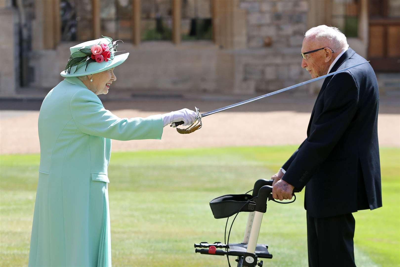 Captain Sir Thomas Moore receiving his knighthood from the Queen during a ceremony at Windsor Castle (Chris Jackson/PA)
