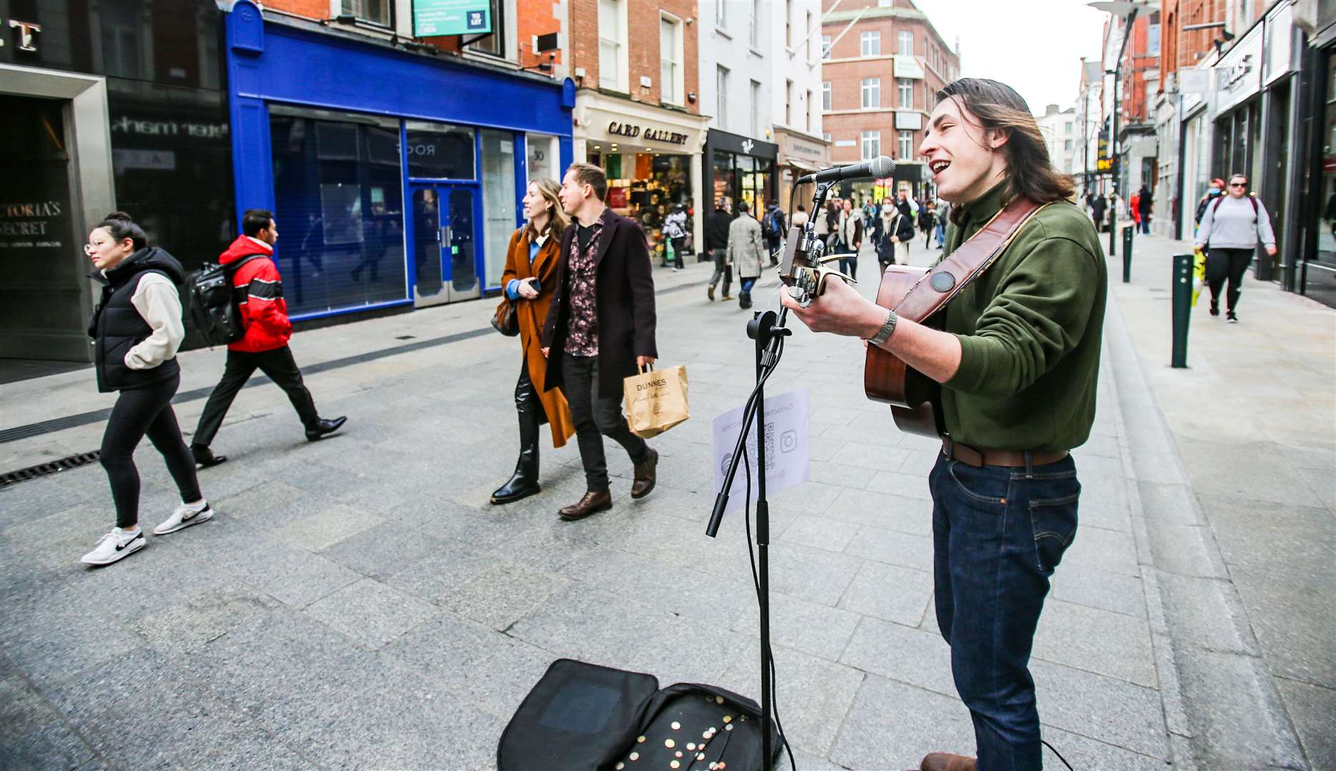 A busker plays to shoppers on Grafton Street in Dublin on Saturday afternoon (Damien Storan/PA)