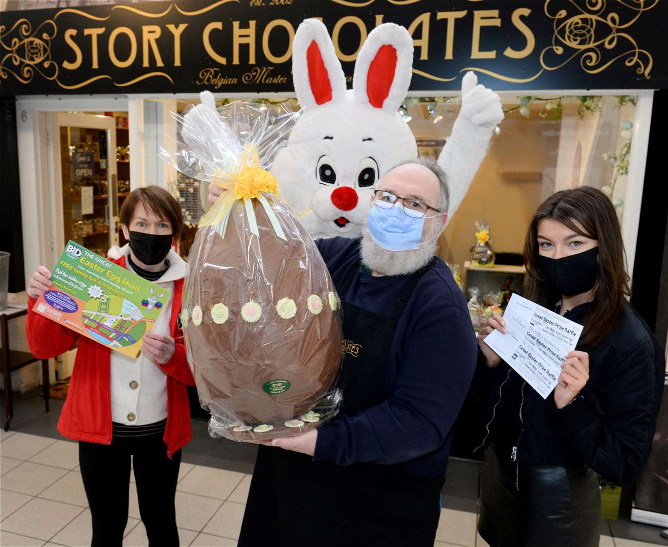 The Easter Bunny joins chocolatier Lucas Storey with Margaret Laws of Inverness BID (left) and Jade MacKenzie of Eastgate Shopping Centre with raffle tickets to win the giant egg. Picture: Gary Anthony