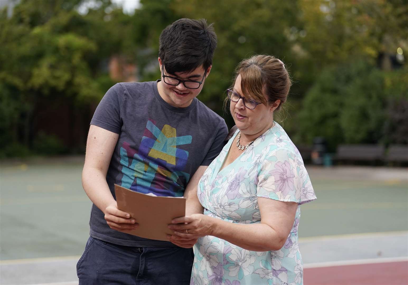 Lorcan Bonser-Wilton looks at his GCSE results with his mother Helen (Andrew Matthews/PA)