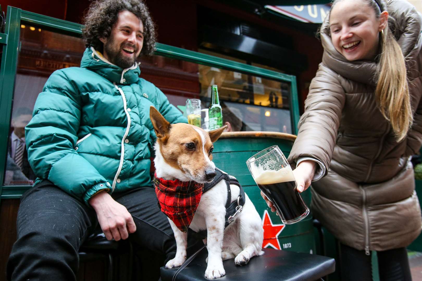 Will and Laura, with their dog Alfie, with a pint at Grogan’s pub in Dublin, on the day coronavirus restrictions were eased (Damien Storan/PA)