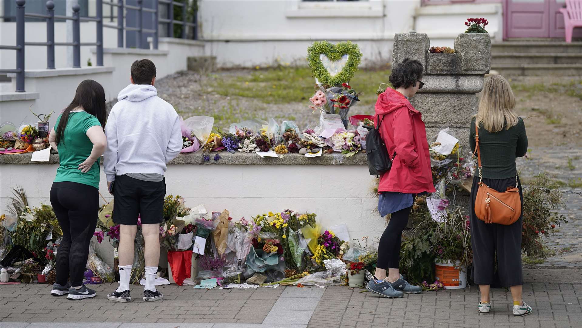 People look at flowers outside Sinead O’Connor’s former home in Bray (Niall Carson/PA)