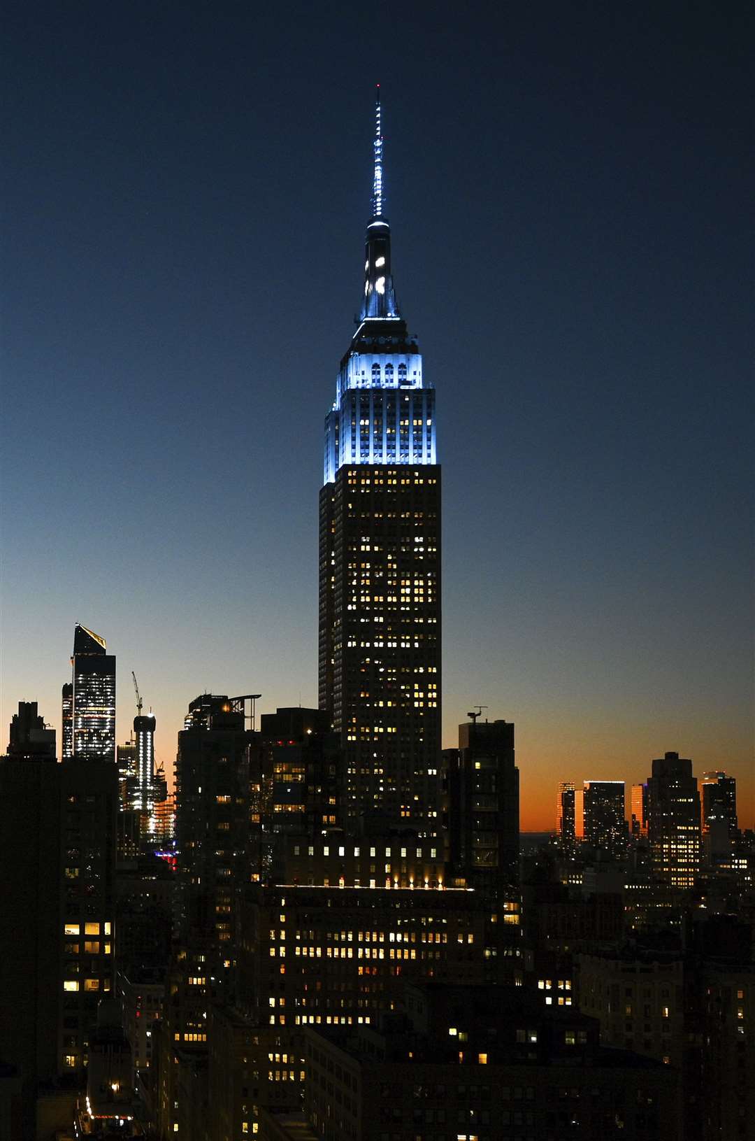 The Empire State Building is illuminated light blue in New York, in honour of what would have been John Lennon’s 80th birthday (Evan Agostini/Invision/AP)