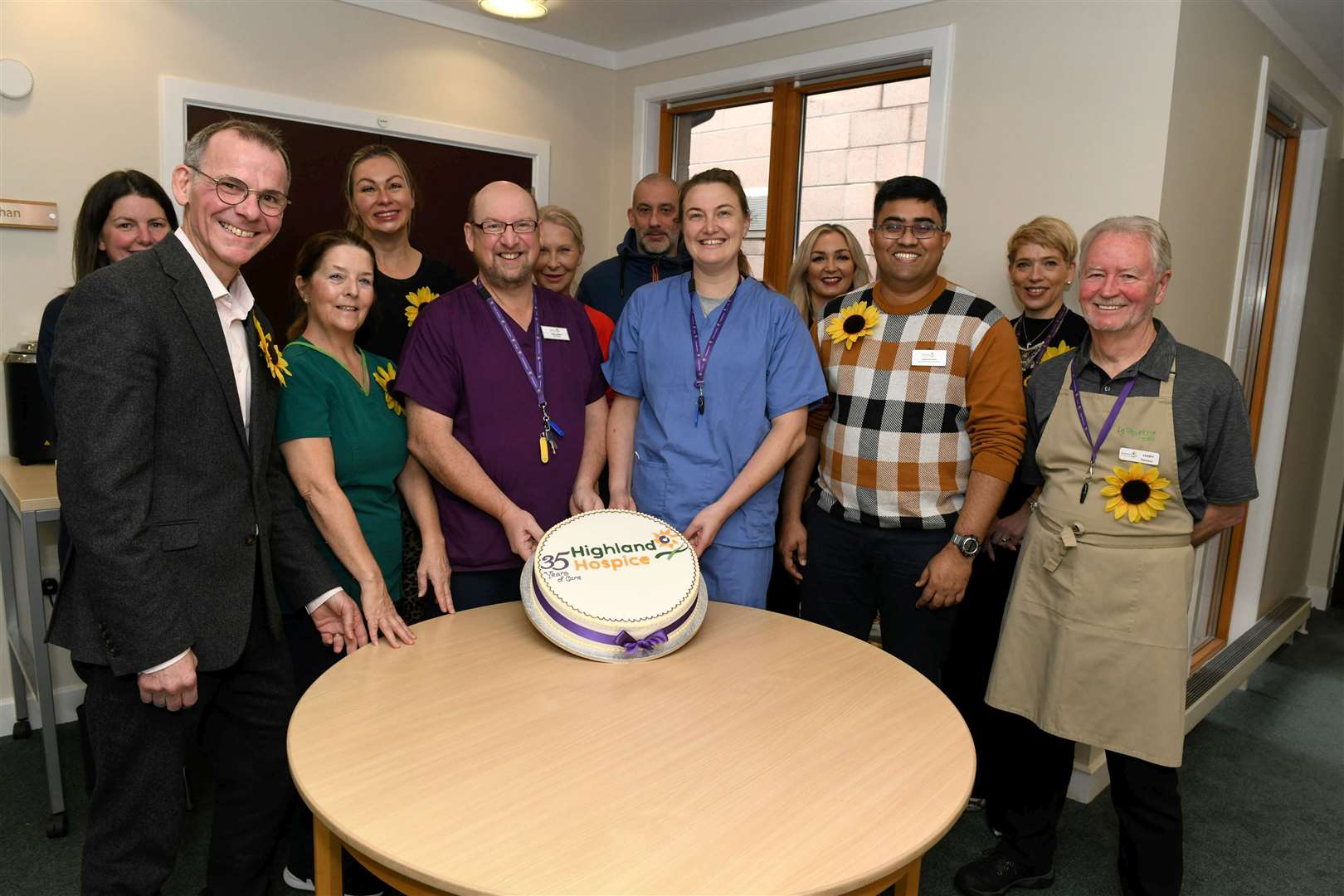 Andrew Leaver (left) with clinical staff/volunteers and cake. Picture: Callum Mackay.
