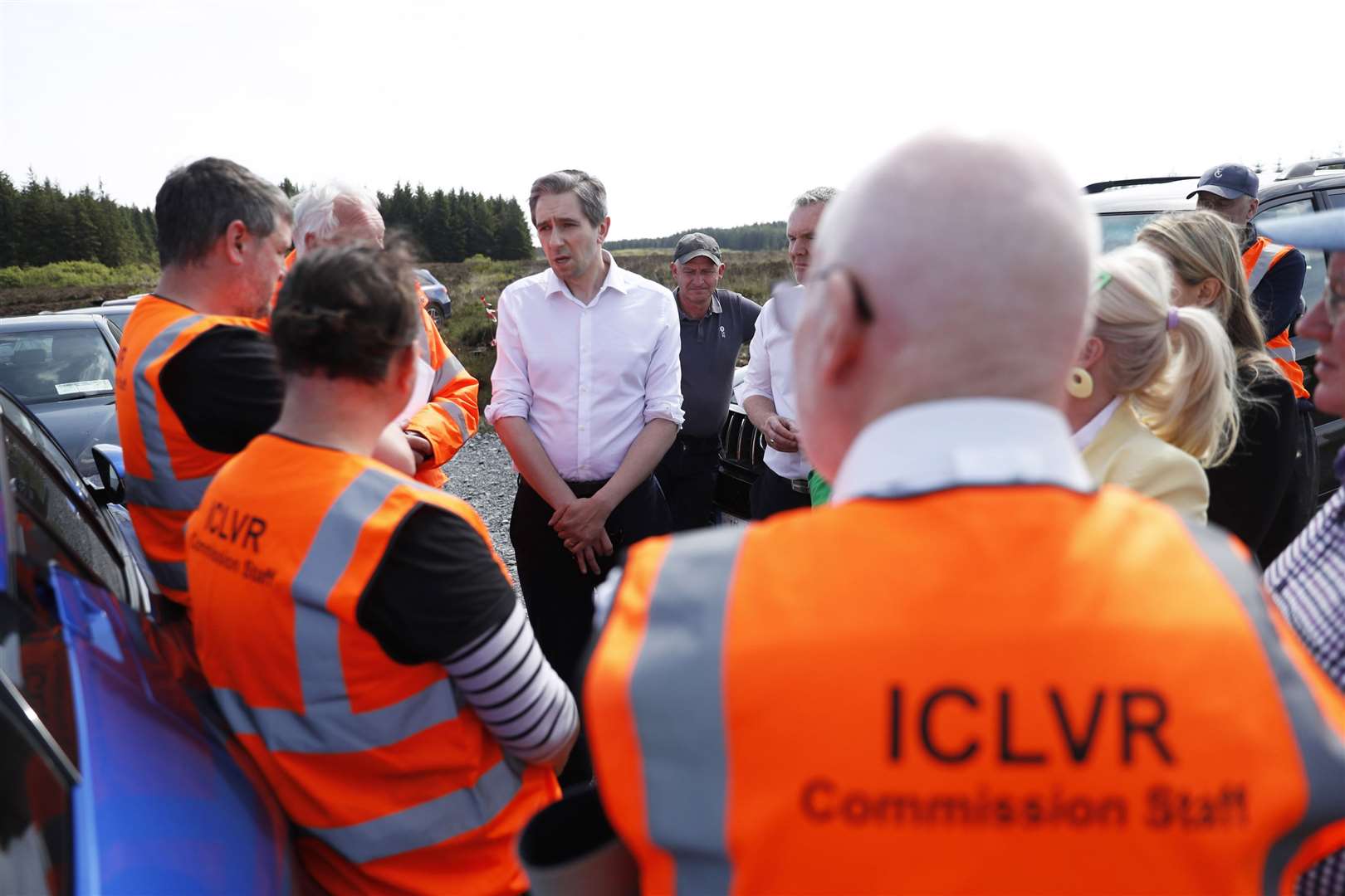 Simon Harris, centre, talks to members of the Independent Commission for the Location of Victims’ Remains during a visit to the remote Bragan Bog in Co Monaghan (Peter Morrison/PA)