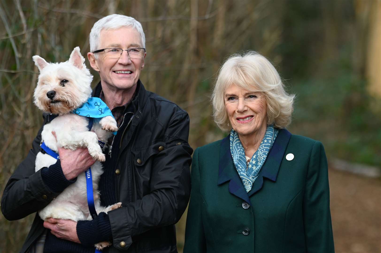The Queen Consort on a walk with Battersea ambassador Paul O’Grady and a rescue dog during her visit to the centre (Stuart Wilson/PA)
