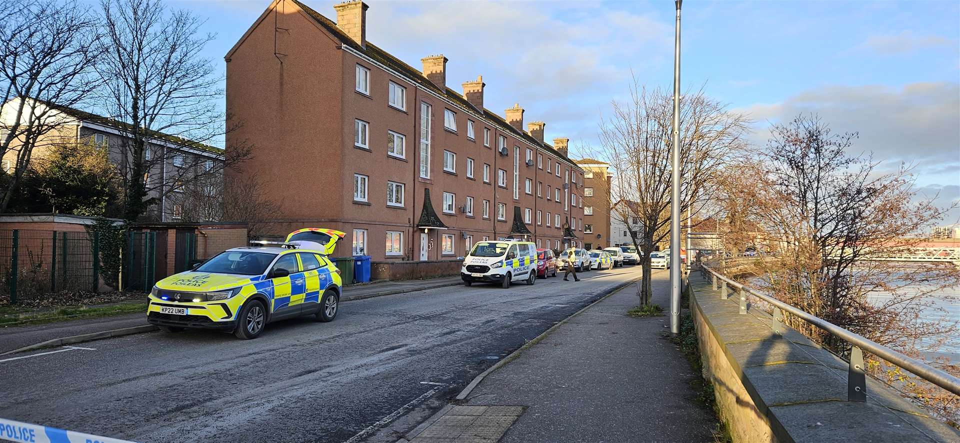 Police officers are at a block of flats in Gilbert Street.