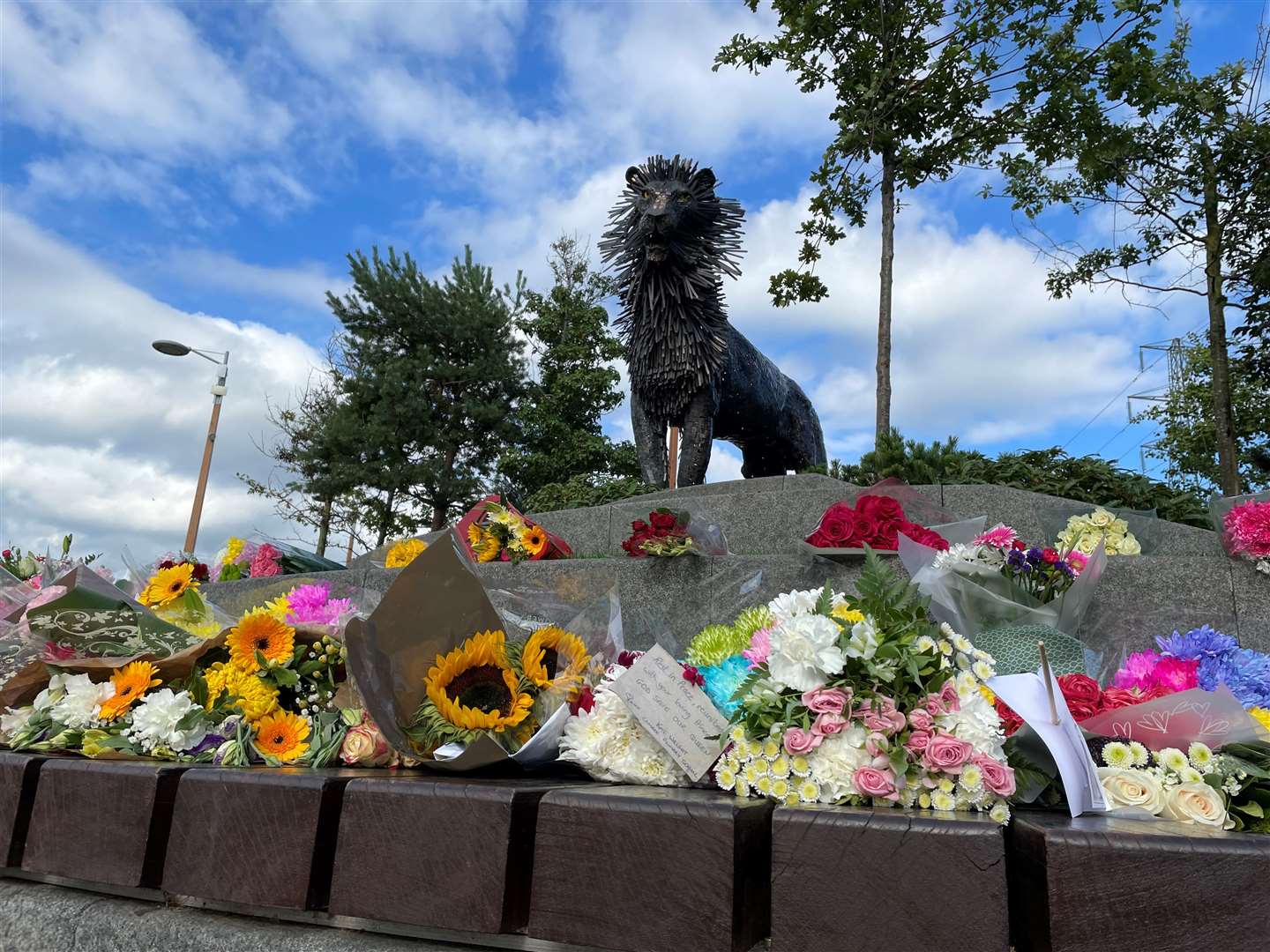 Floral tributes at the Aslan statue in CS Lewis Square in east Belfast (David Young/PA)