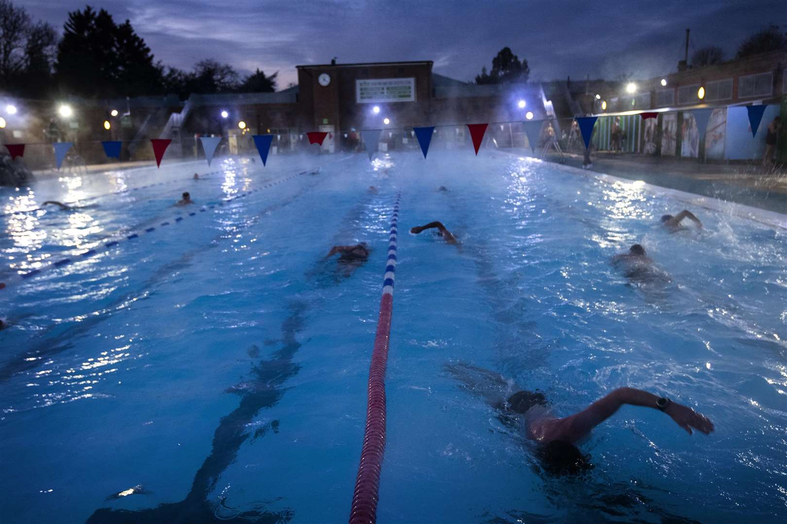 It was stlll dark when some swimmers took the plunge at London’s Charlton Lido (Victoria Jones/PA)
