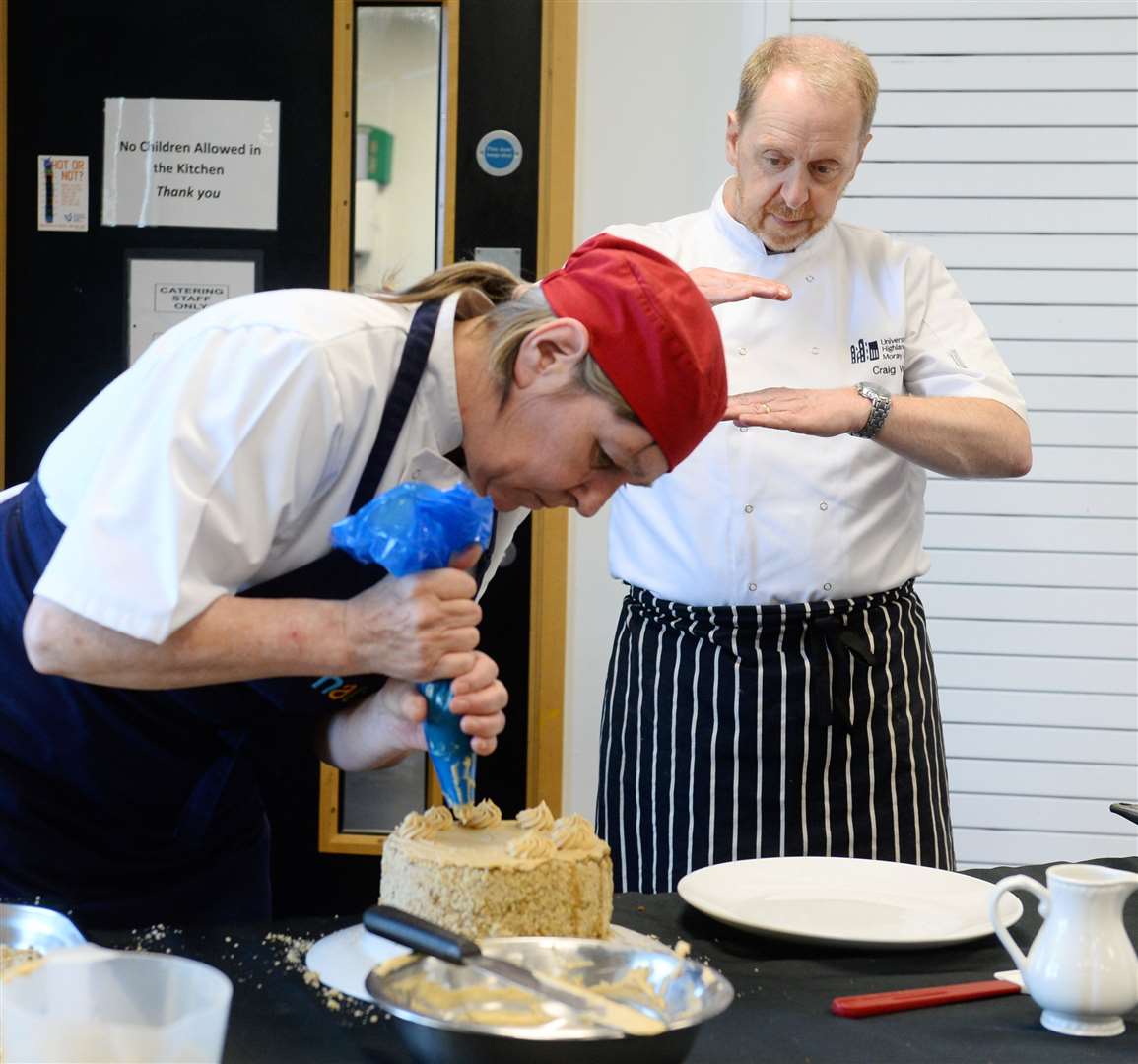 Moray College student Donna Cunningham with Craig Wilson demonstrates creating gateau. Picture: Gary Anthony