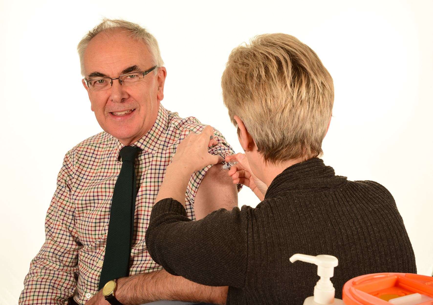 Professor Boyd Robertson receives his flu vaccination.