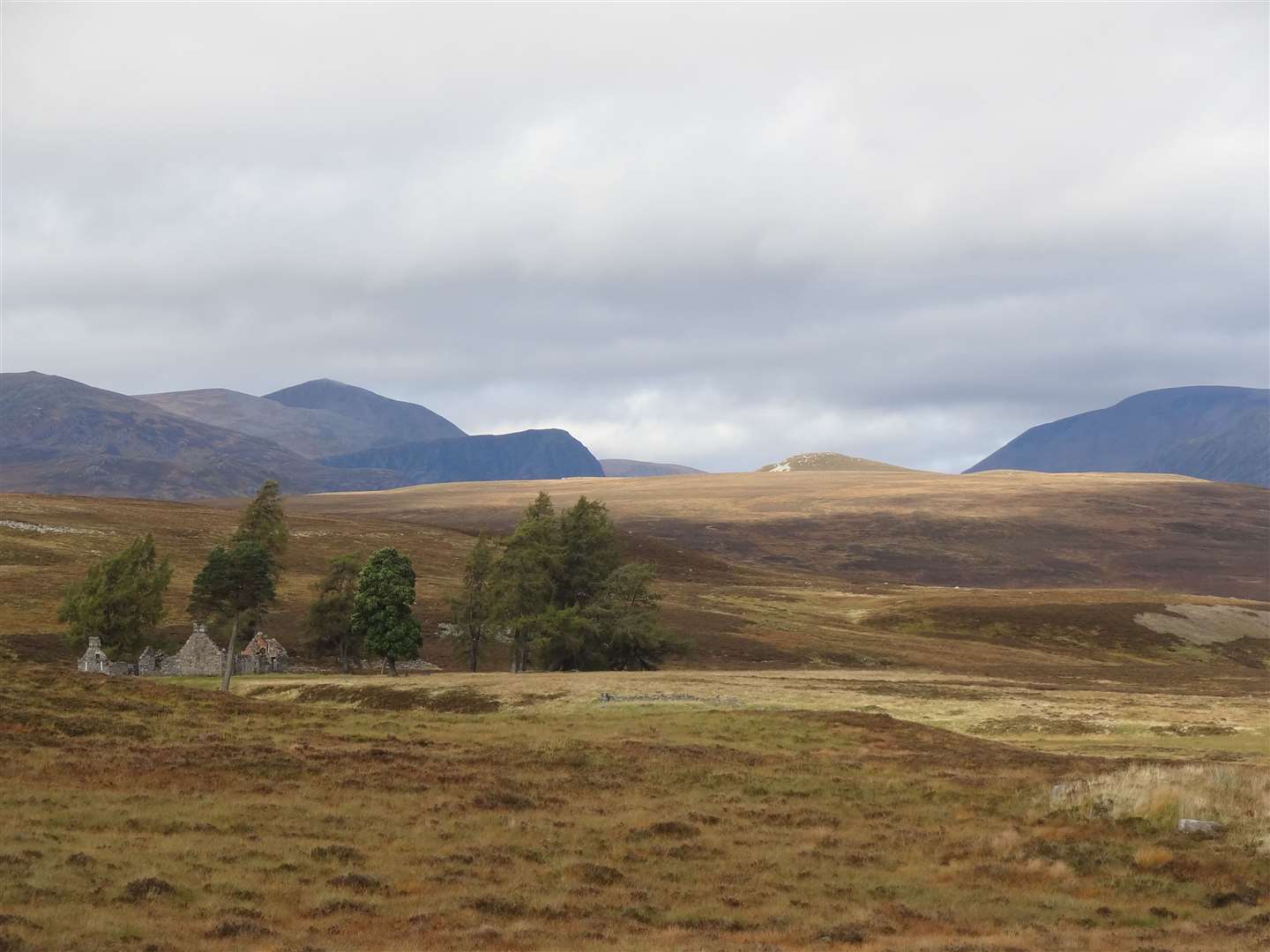 The ruins of Bynack Lodge and the mountains of the Cairngorms ahead.