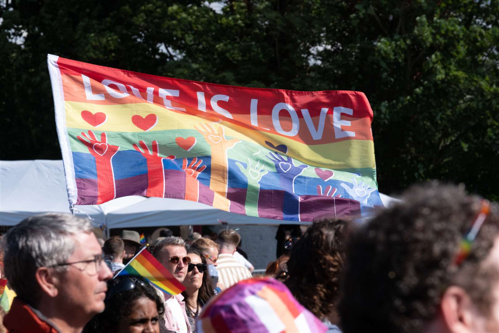 Highland Pride 2023: A "Love is Love" flag in the crowd at Party in the Park. Picture: Alexander Williamson