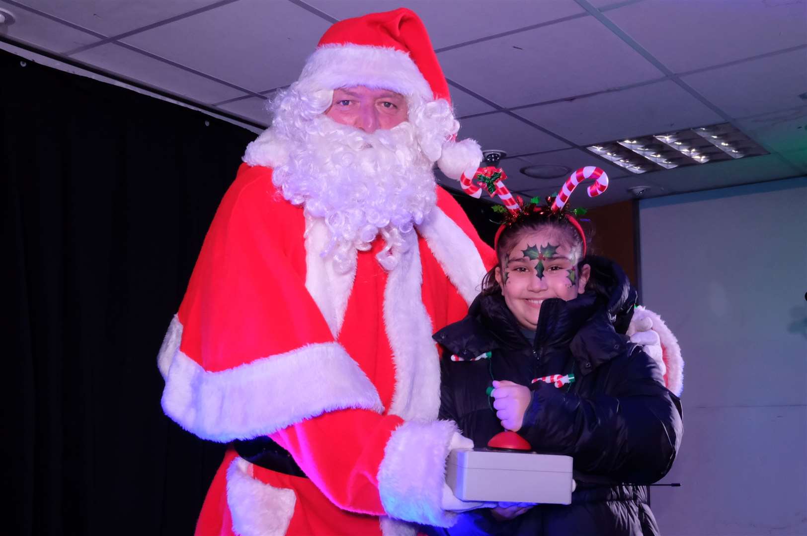 Lily Saleh, pictured with Santa, won the opportunity to put on the lights.