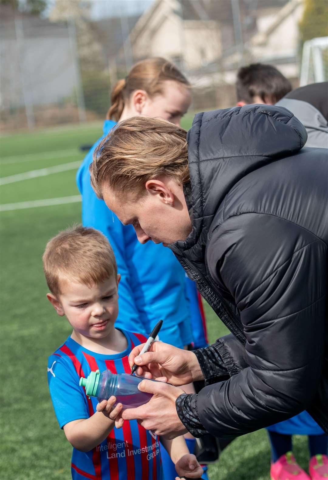 Alex Samuel signing a young players water bottle. Picture: Callum Mackay.