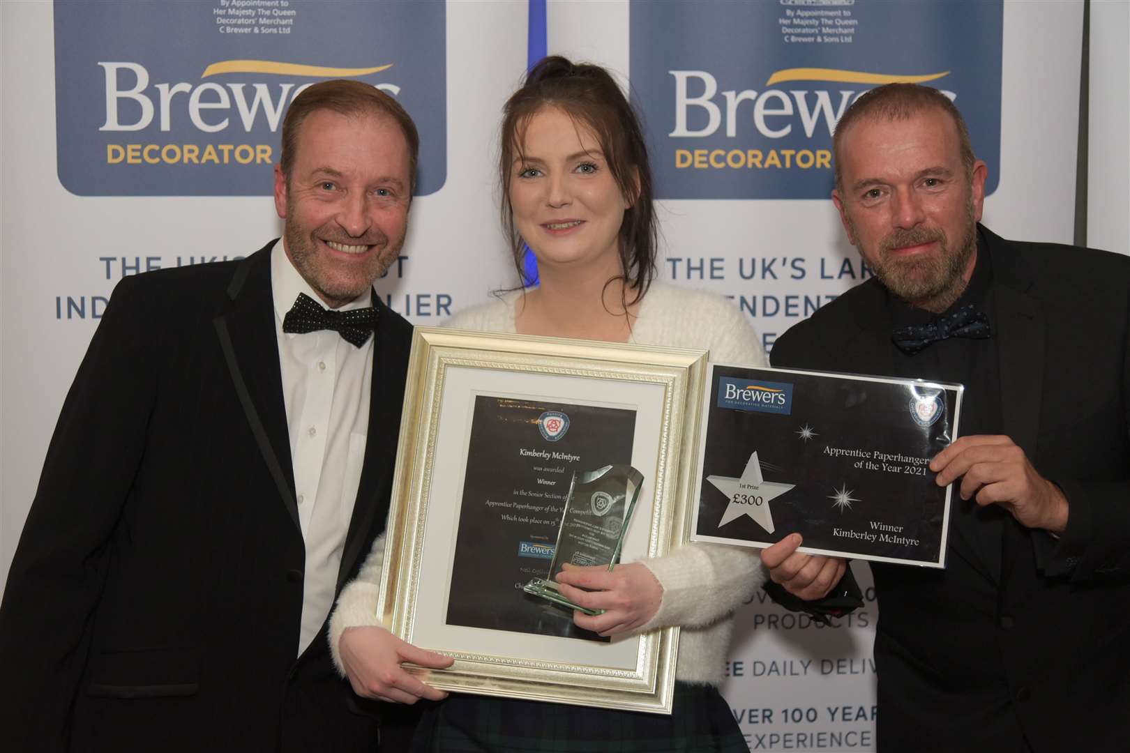 Senior winner Kimberley McIntyre with PDA chief executive Neil Ogilvie (left) and Dave Hope from competition sponsor, Brewers Decorator Centres.