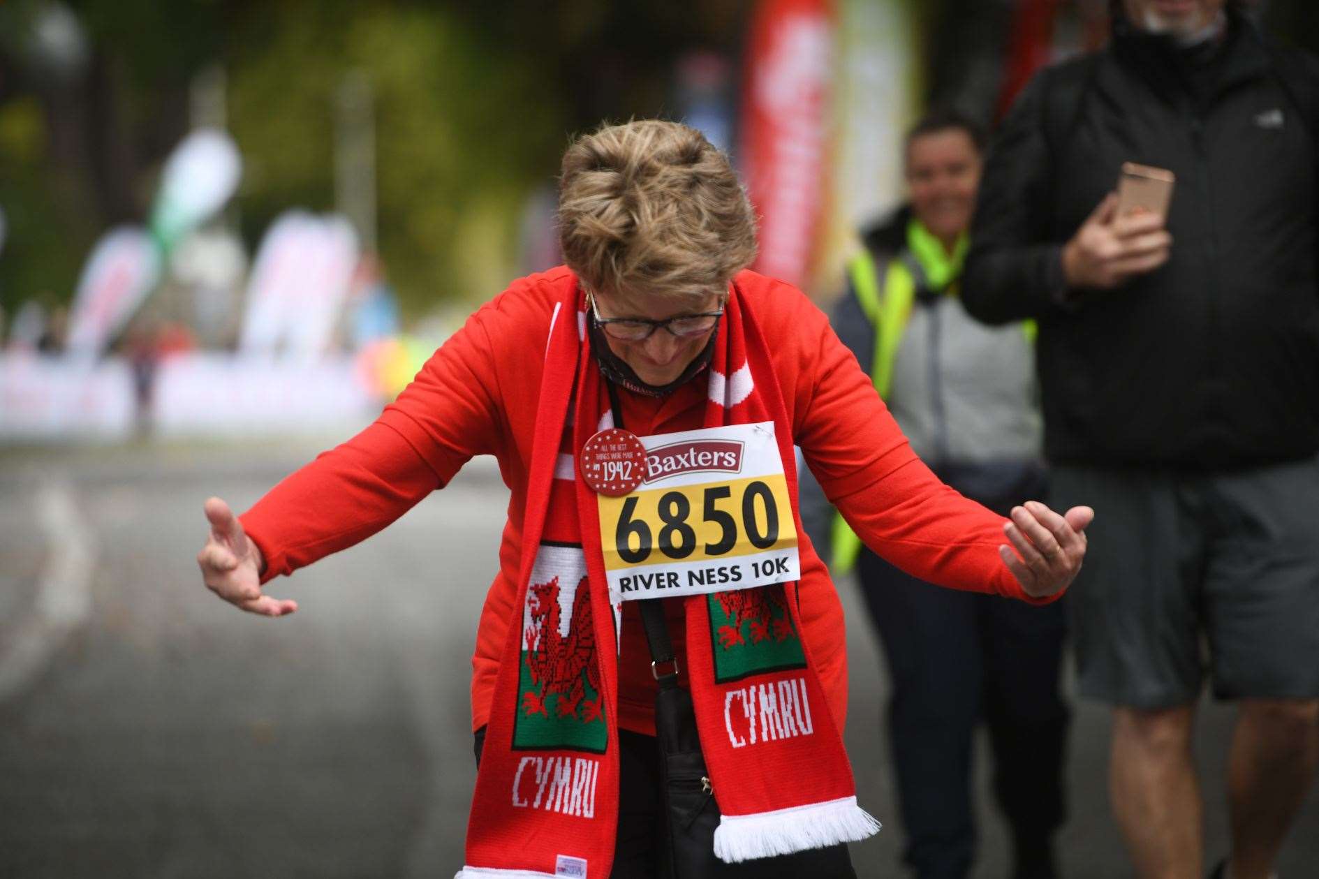 Hazel Kelly, 80 years old, taking a bow after finishing the 10k Picture: James Mackenzie