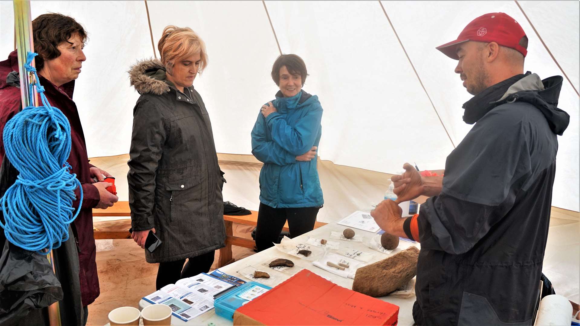 Rick Barton, project officer at the dig, shows some of the items recovered to members of the public at the open day event last year. Picture: DGS