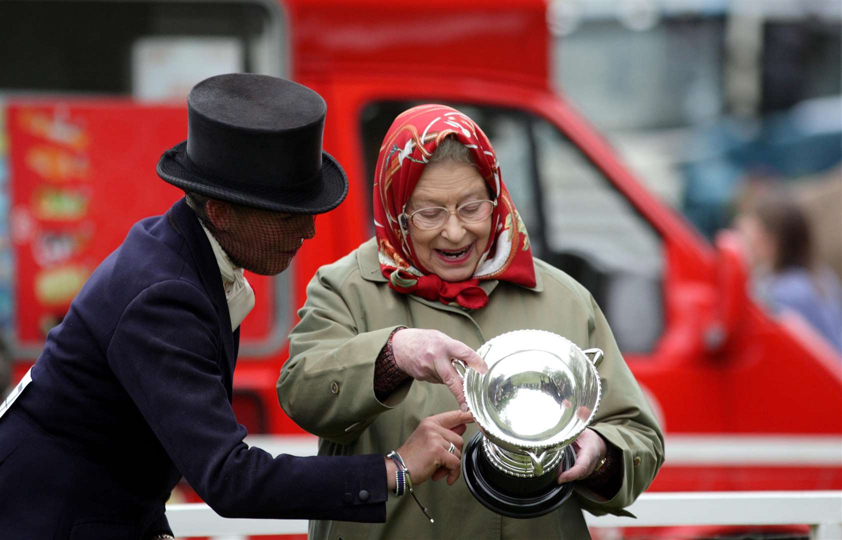 The Queen looks at the cup that her horse Stardust III won at the Royal Windsor Horse Show (Steve Parsons/PA)