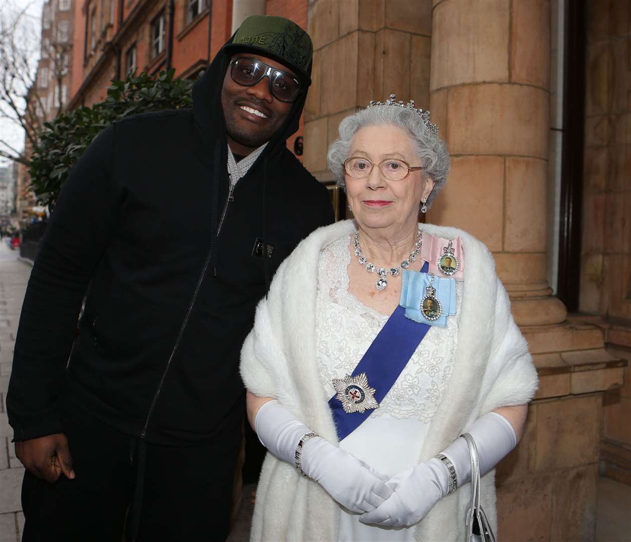 Queen Elizabeth look-alike Mary Reynolds poses with boxer Dereck Chisora. Ms Reynolds described the late monarch as ‘well-loved’ and someone who had ‘so much light’ (Nick Potts/PA)