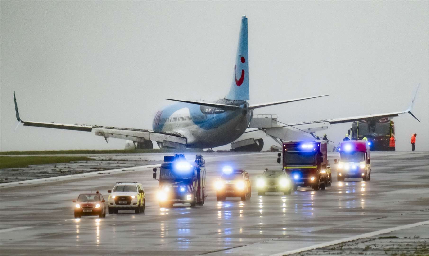 Emergency services at the scene after a passenger plane came off the runway at Leeds Bradford Airport while landing in windy conditions during Storm Babet (Danny Lawson/PA)