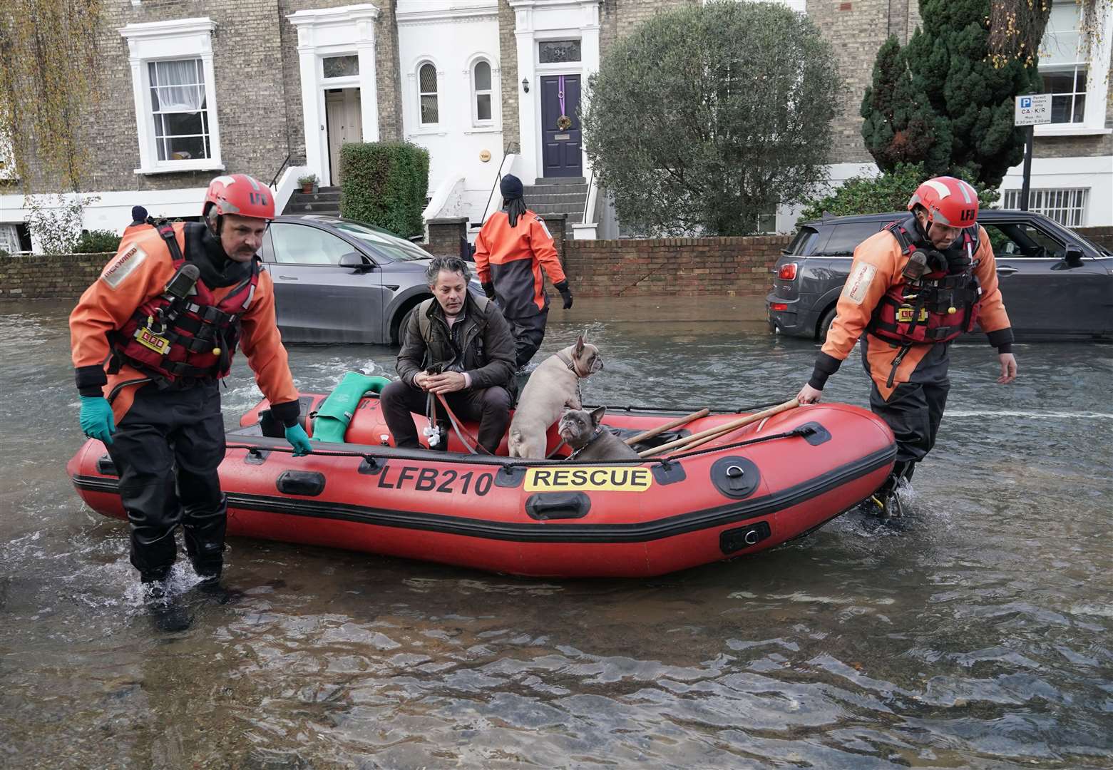Emergency services rescue resident Stefano Calcagni and dogs Batista and Pandora (Yui Mok/PA)