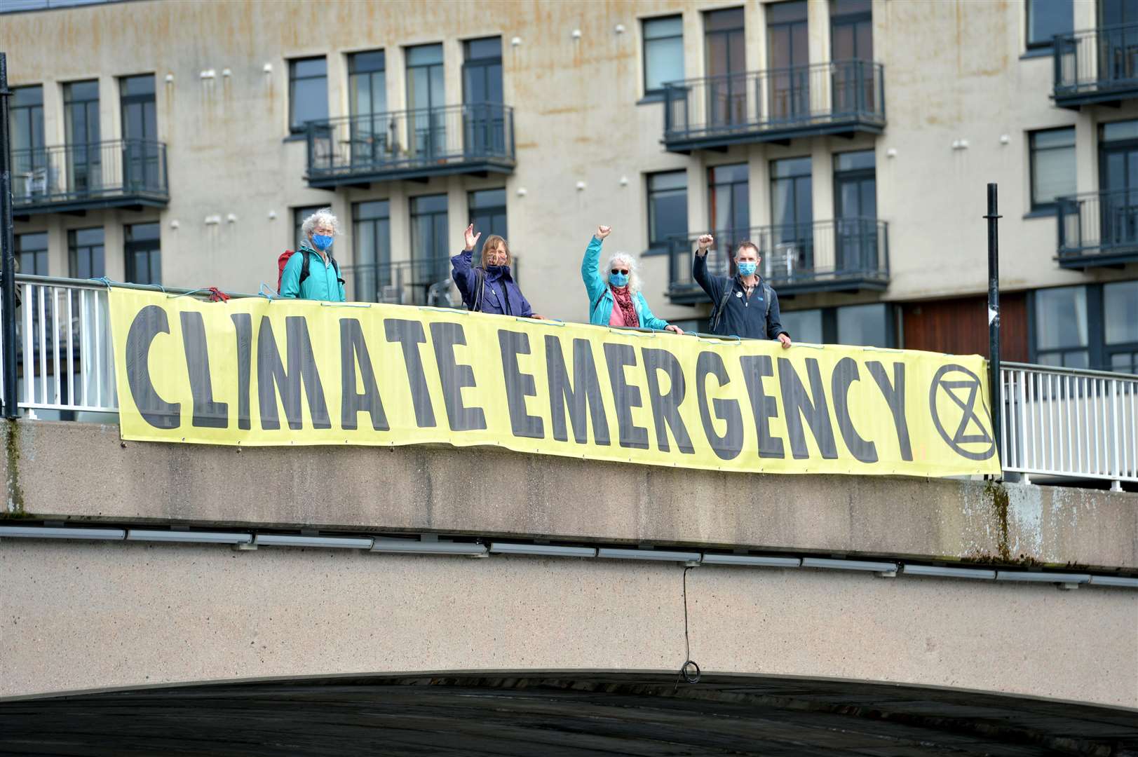 Extinction rebellion (XR) drop banners over Ness Bridge and protestors carrying flags and placards over role of banks in funding fossil fuels. Picture: Callum Mackay.